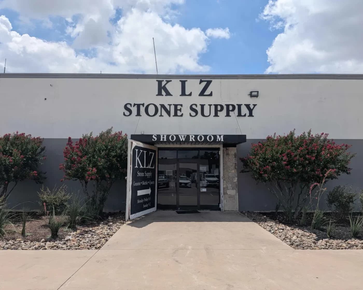 The KLZ building on Zodiac Lane in Dallas, with the showroom entrance under the sign
